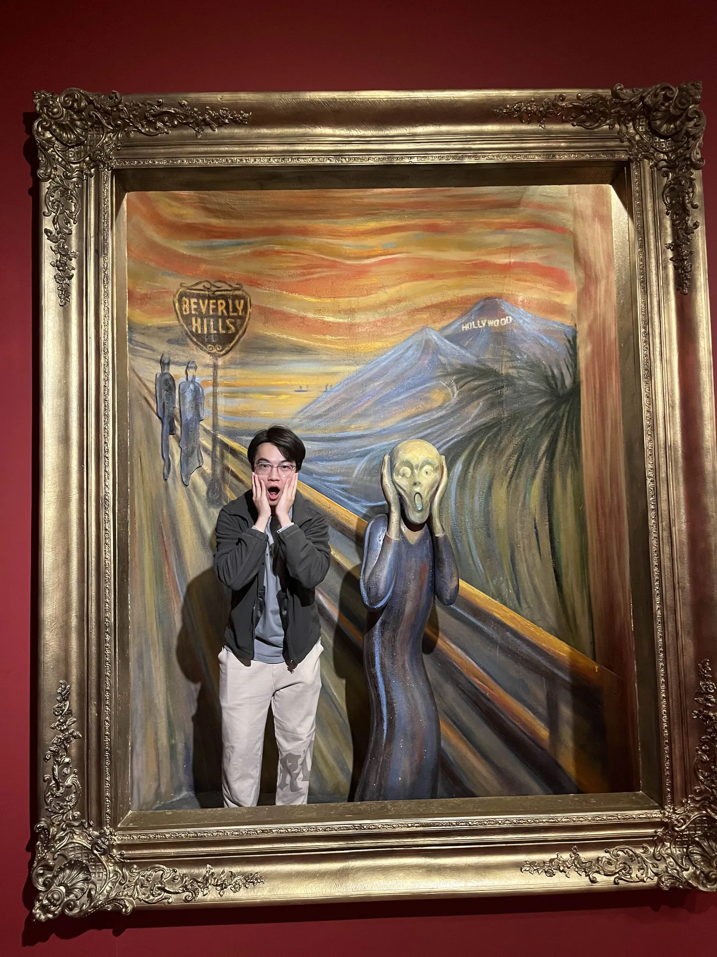 Lucas Qu posing beside a Scream-inspired figure